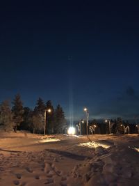View of illuminated street lights at night