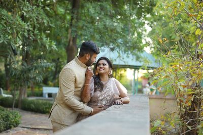 Young couple sitting outdoors