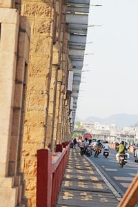 People walking on road amidst buildings in city