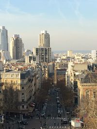 High angle view of city street and buildings against sky