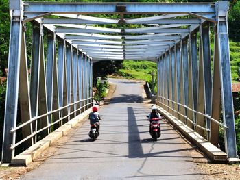 Rear view of motorcycling on road