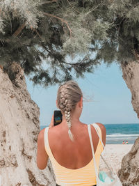 Rear view of woman walking on beach