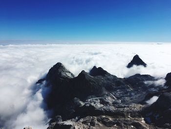 Scenic view of sea and snowcapped mountains against sky