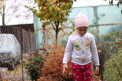 Portrait of cute girl standing in garden