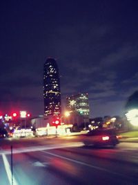 Illuminated city against sky at night