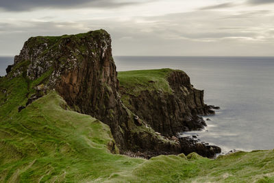 Scenic view of rock formation by sea against sky