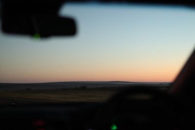 Scenic view of silhouette landscape against clear sky at sunset