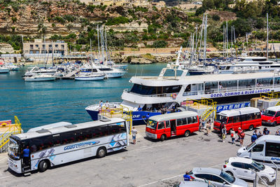 High angle view of sailboats moored on harbor in city