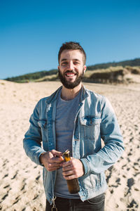 Portrait of young man standing outdoors