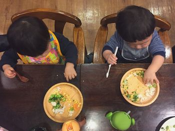 Directly above shot of babies having food at table