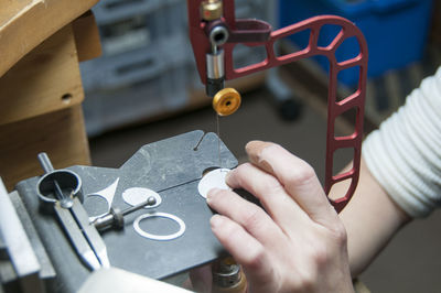 Close-up of woman with sewing machine