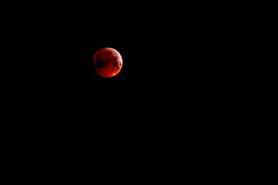 Red moon against sky at night