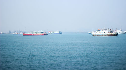 Ship sailing on sea against clear sky