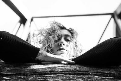 Portrait of woman with dog lying on floor