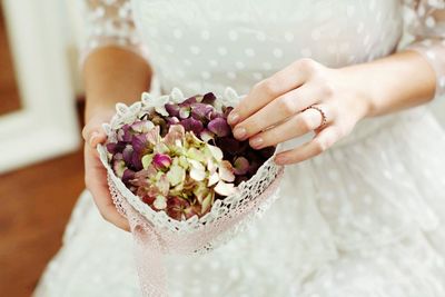 Cropped image of person holding bouquet