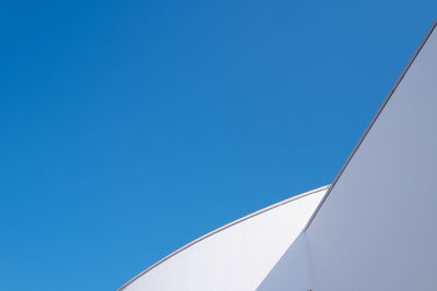 Low angle view of building against clear blue sky