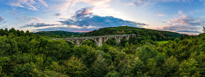 Panoramic view of bridge and mountains against sky