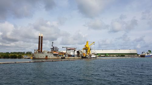 Panoramic view of commercial dock against sky