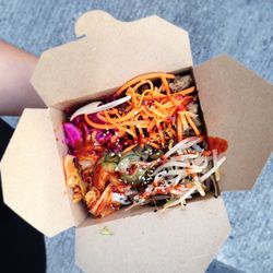 Cropped image of person holding salad contained in box