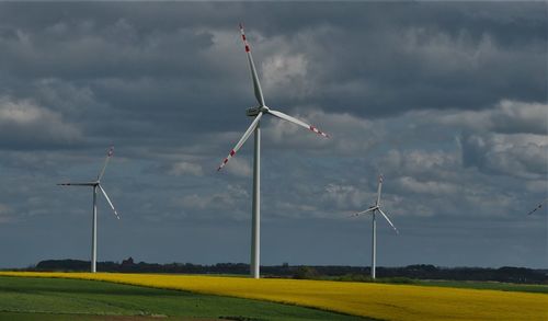 Windmill on field against sky