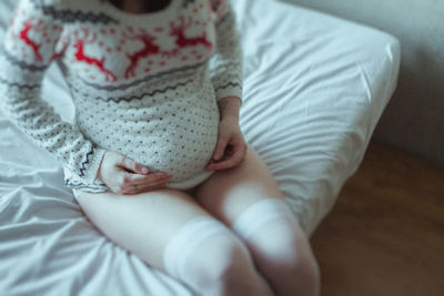 High angle view of woman lying on bed