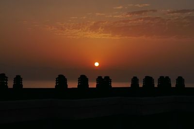 Silhouette landscape against romantic sky at sunset