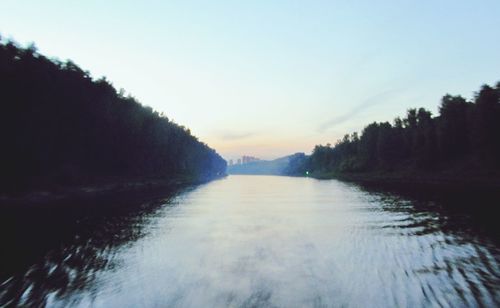 Scenic view of lake against sky at sunset