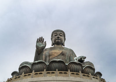 Gate in the ngong ping village with tian tan big buddha in the dstance on lantau island, hong kong