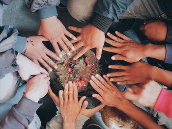 High angle view of people warming hands over fire