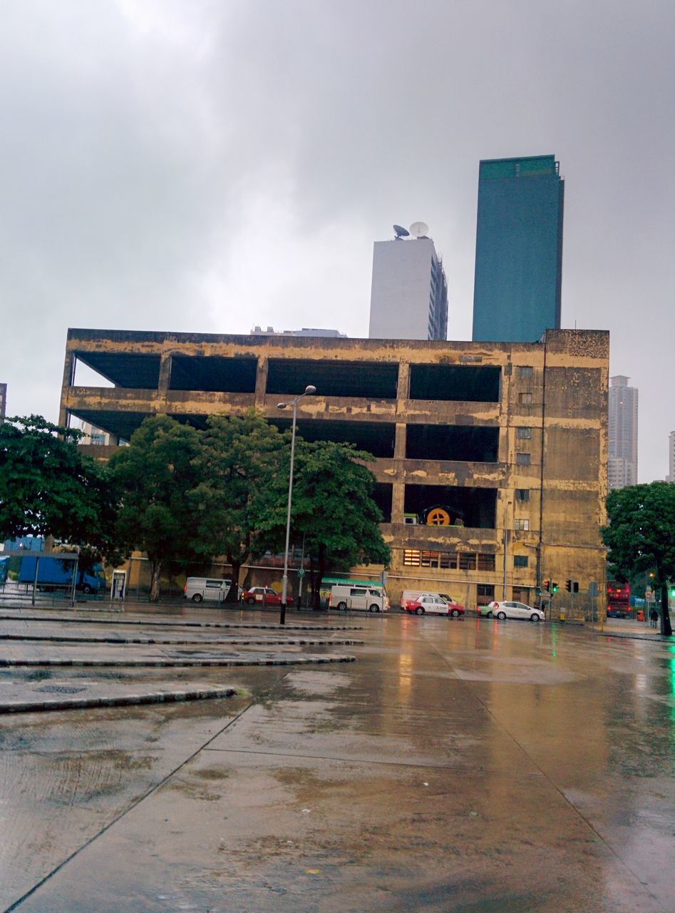 architecture, built structure, sky, city, building exterior, weather, cloud - sky, street, skyscraper, outdoors, no people, day, modern, tree, cityscape