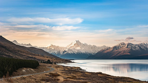 Scenic view of snowcapped mountains against sky during sunset