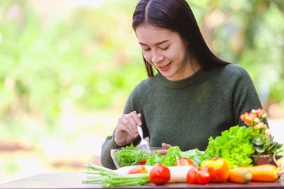 Young woman holding food outdoors