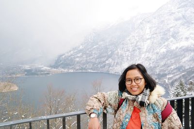 Portrait of smiling woman wearing warm clothing during winter