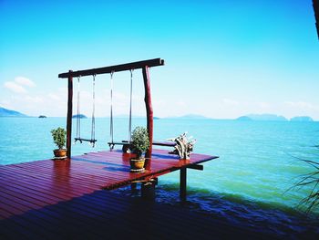 Gazebo on table by sea against sky