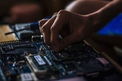 Human hand holding cake circuit board