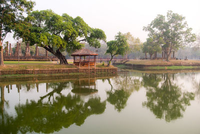 Reflection of trees in lake against sky