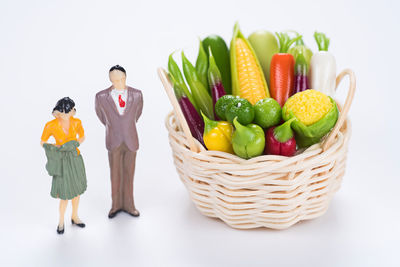 Fruits in basket against white background