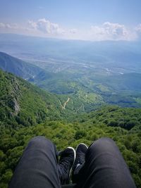 Low section of person over landscape