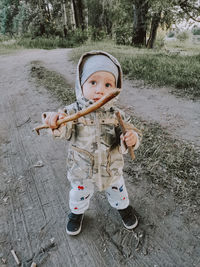 Portrait of cute boy standing outdoors