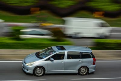 Side view of blurred motion of car on road