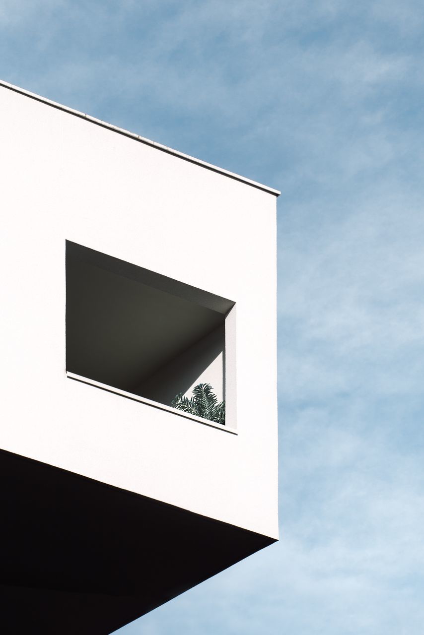 sky, low angle view, built structure, architecture, cloud - sky, no people, building exterior, day, nature, building, outdoors, white color, wall - building feature, geometric shape, communication, sign, sunlight, shape, blue, close-up, directly below