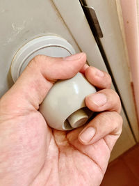 Cropped hand holding doorknob