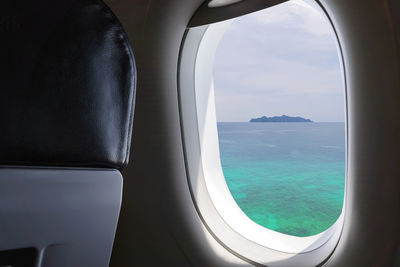 View of sea seen through airplane window