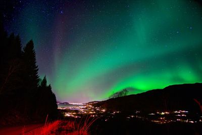 Scenic view of illuminated mountains against sky at night