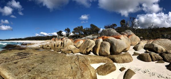 Panoramic view of rocks on beach against sky