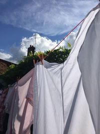 Low angle view of clothesline against sky