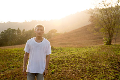 Portrait of man standing on grass