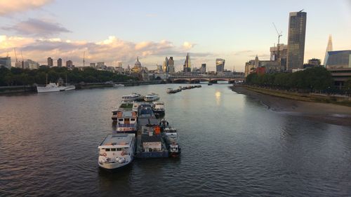 View of boats in river at sunset