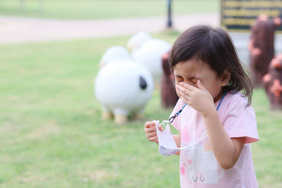 4 years old cute asian girl, little sick child blowing nose with flu symptoms coughing. flu concept.