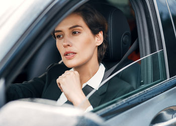 Thoughtful businesswoman driving car
